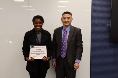 professor zhou and graduate student Christabel Adjah-Tetteh with an award certificate